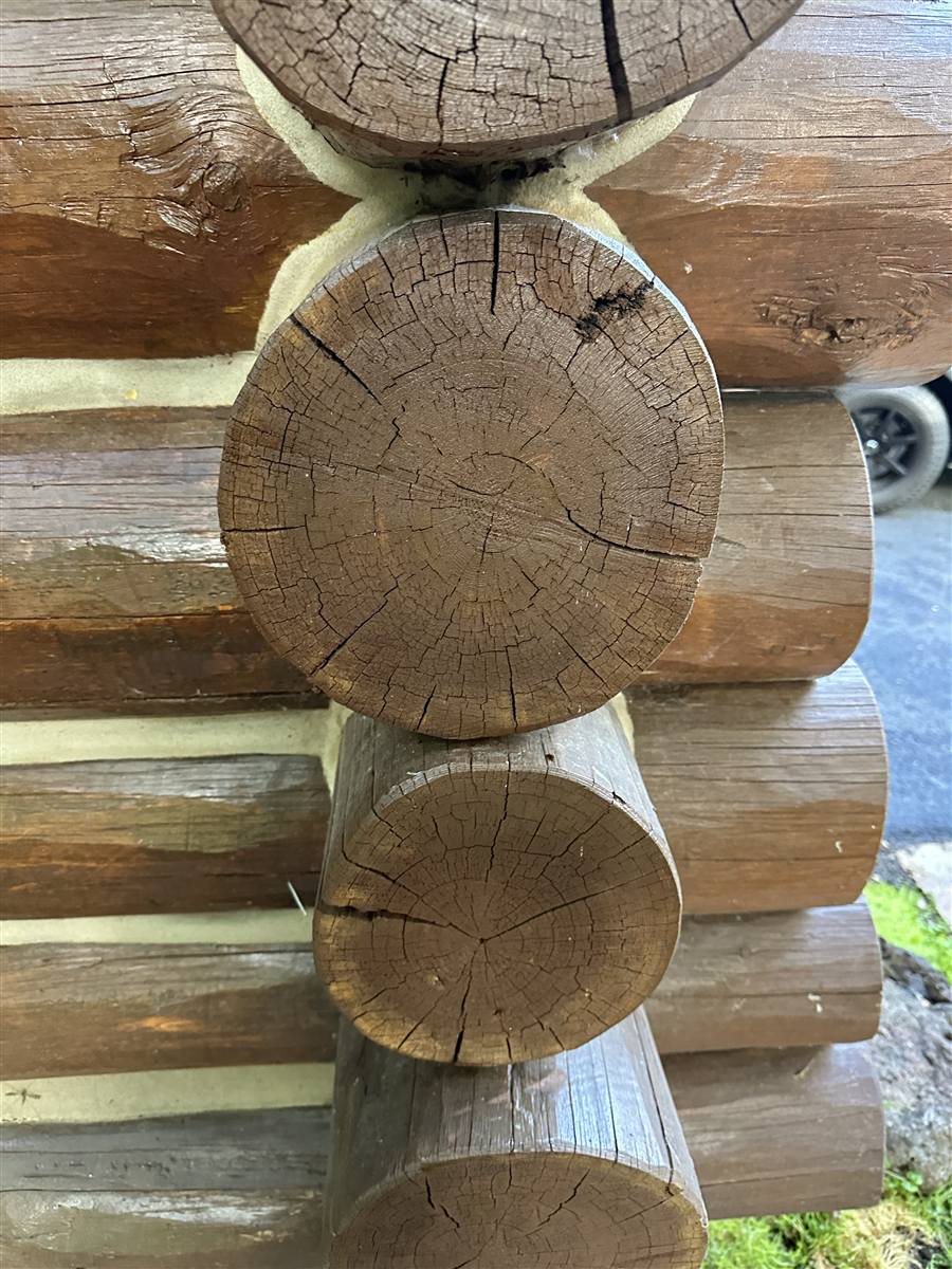 Close-up of clean chinking lines between stained log ends on a Sun Valley log home corner