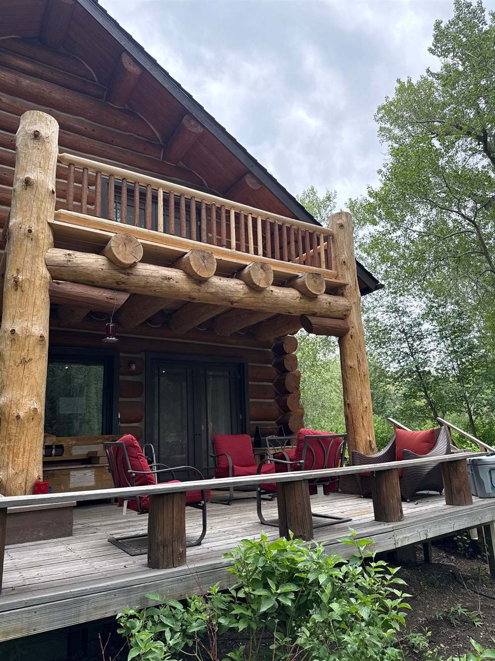 Rebuilt log balcony with hand-peeled posts and beam