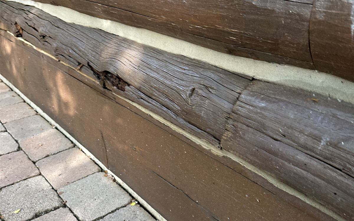 Chinking lines between stained logs on a Sun Valley log home wall